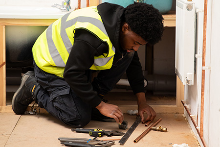 A student bending pipes in the workshop